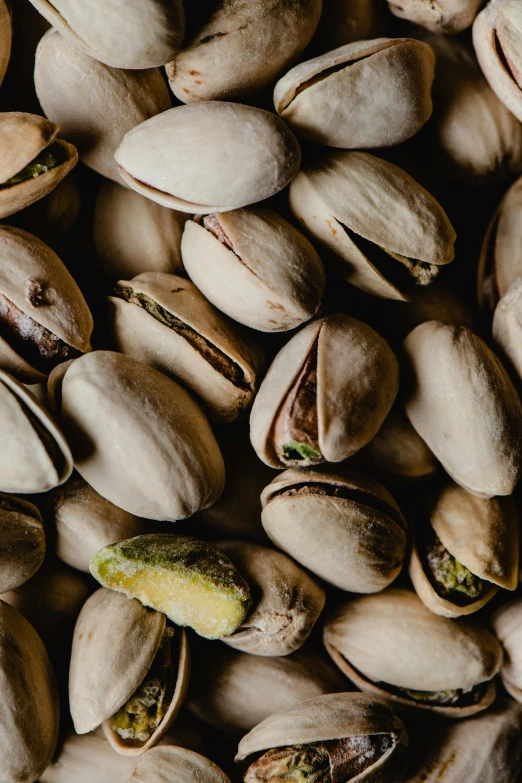 pistachios scattered across the image of a black table