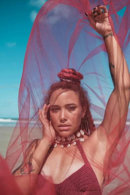 a woman in a bikini standing by the ocean