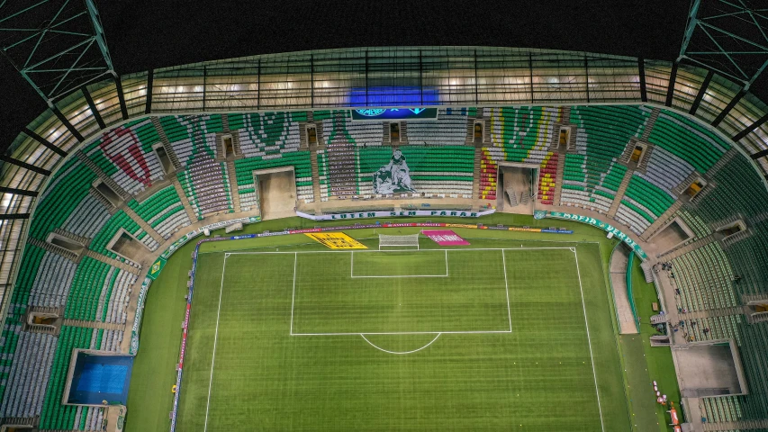 aerial view of stadium with illuminated field and spectators