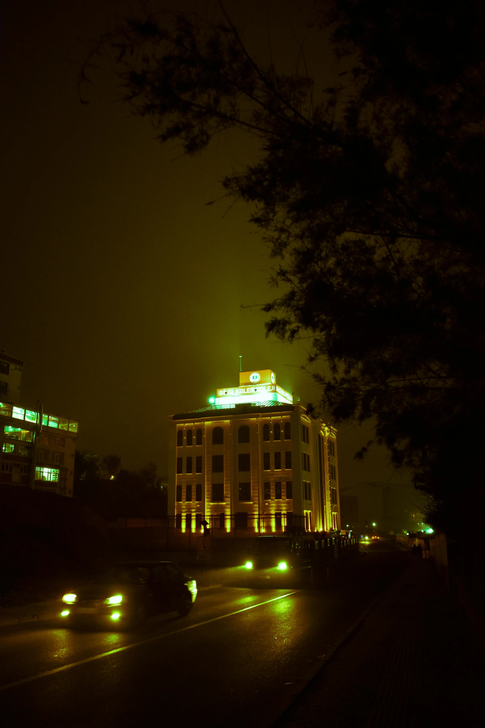 two lights on top of a tall building in the dark