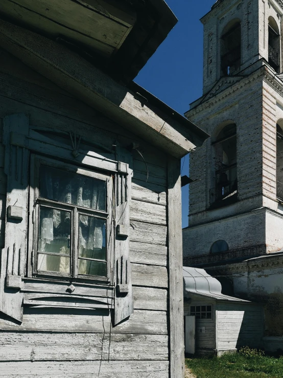 an old and weathered building with a clock tower