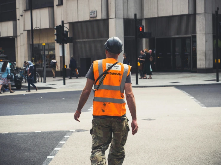 the man is walking across the cross walk