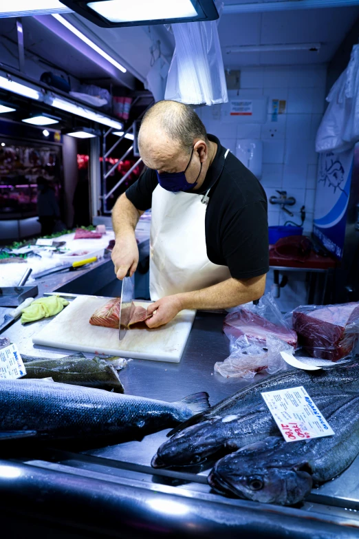 a man is preparing fish for dinner on the counter