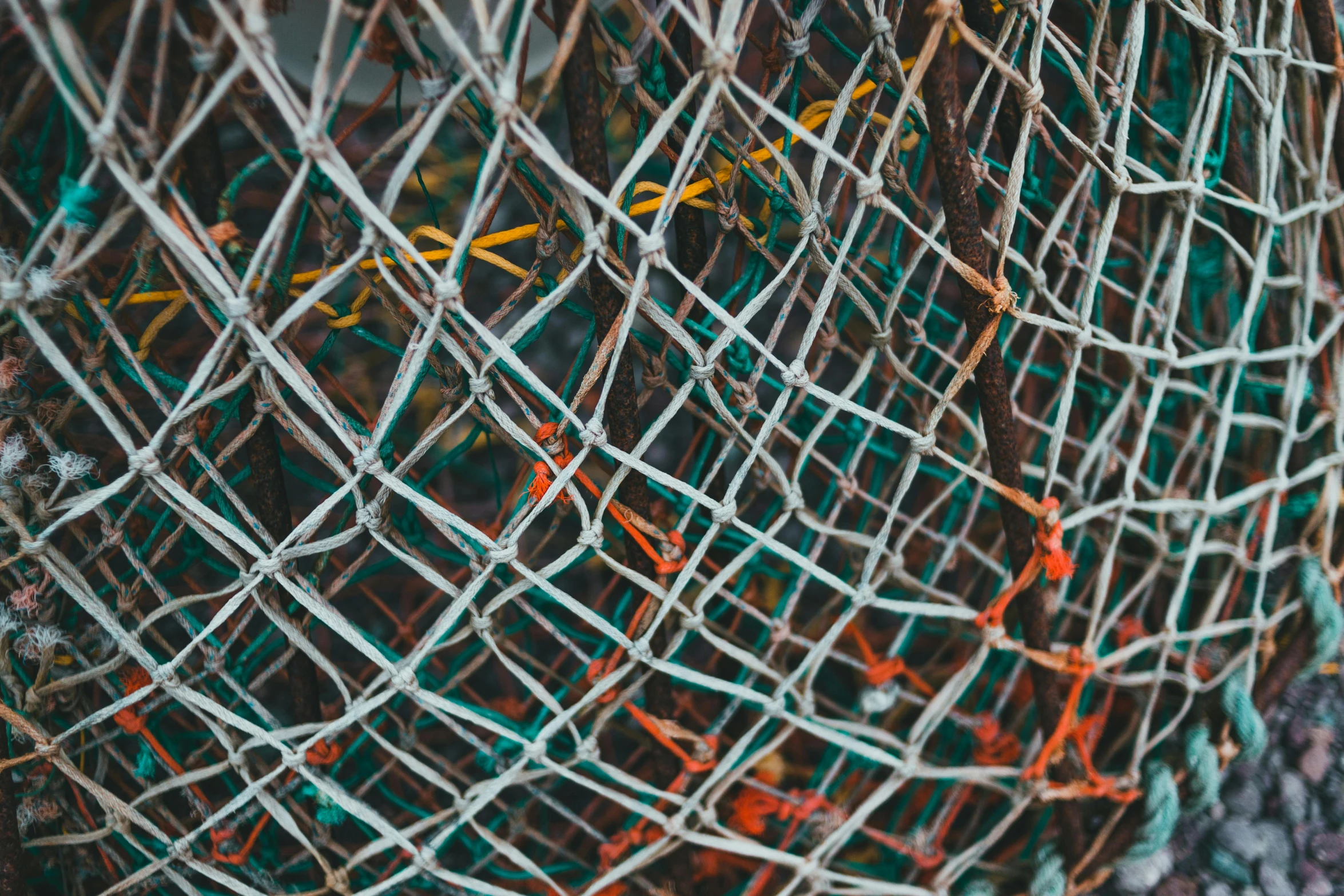 a large net sitting on the ground filled with wires