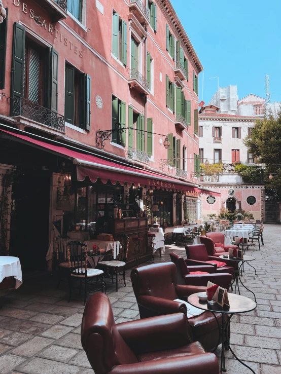 an outdoor patio with tables, chairs and tables with awnings