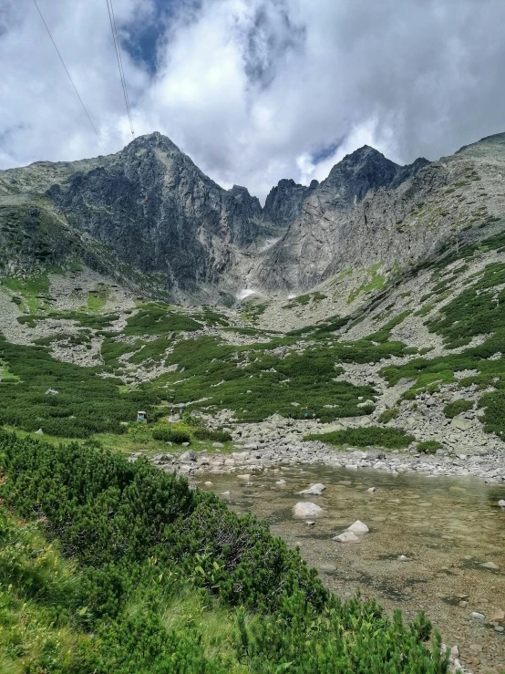 a very scenic and peaceful mountain view with power lines above