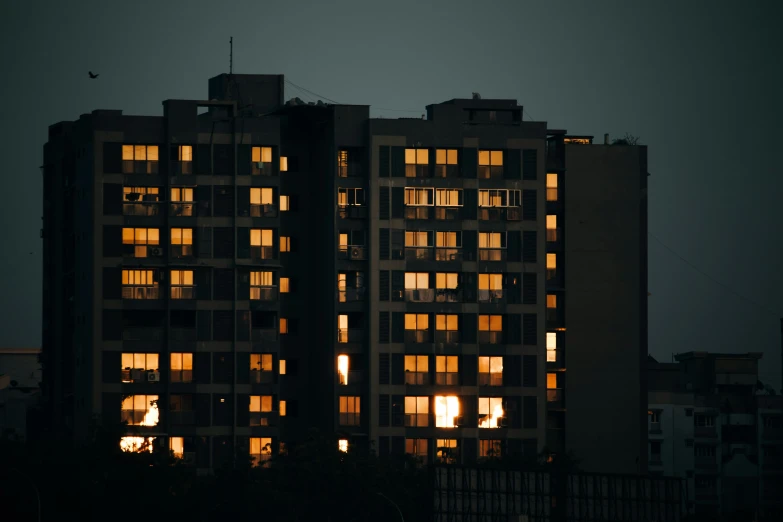 dark apartment buildings are lit up at night