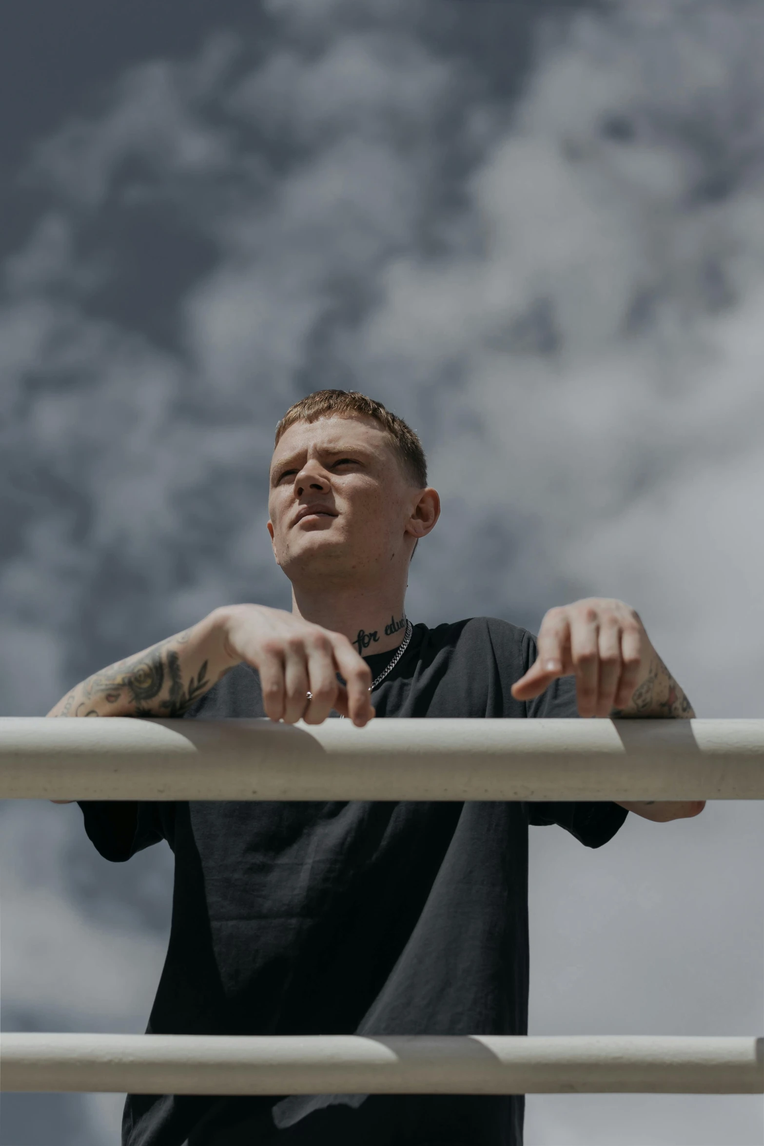 a man with his hands on a white railing