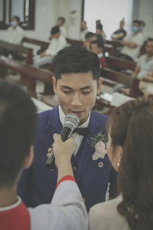 a young man getting ready to sing into a microphone