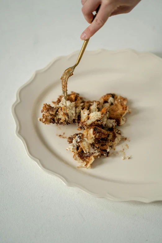 a white plate topped with a small piece of cake