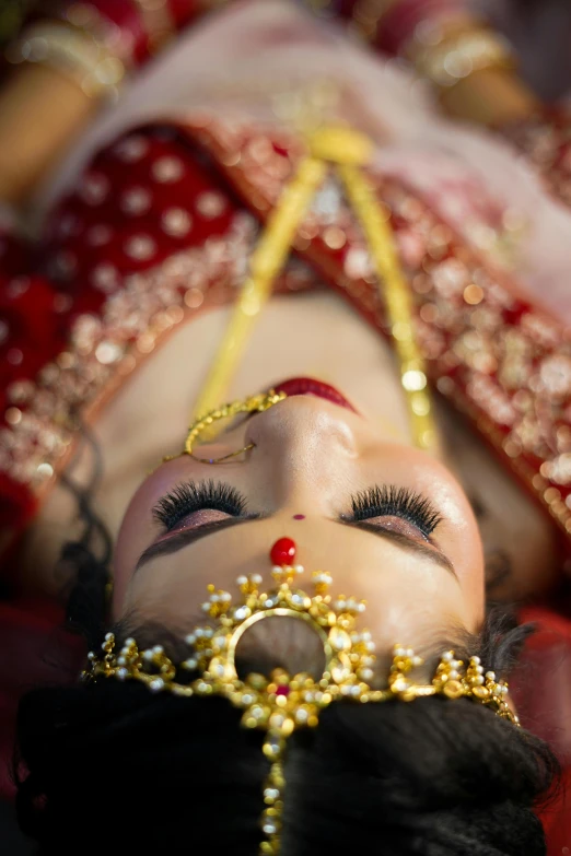 the woman's head is wearing a crown with an oriental face piece