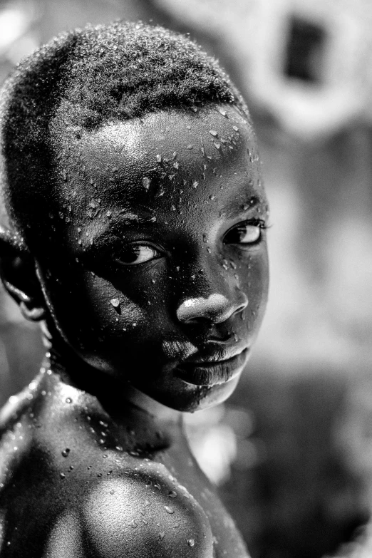 a child with black face paint on his head and body