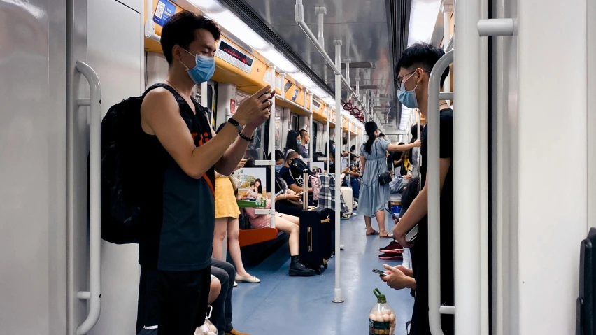 there are many people standing on the subway train