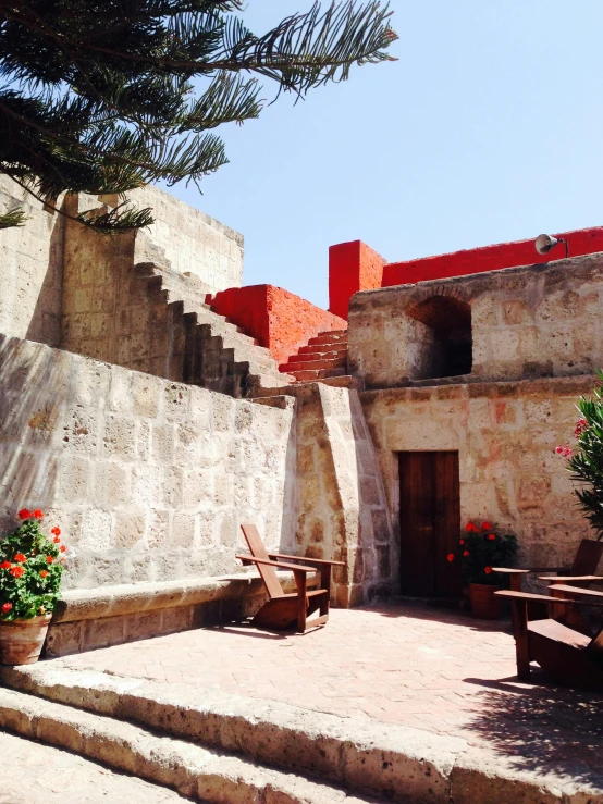 an outdoor setting featuring wooden seats and tables