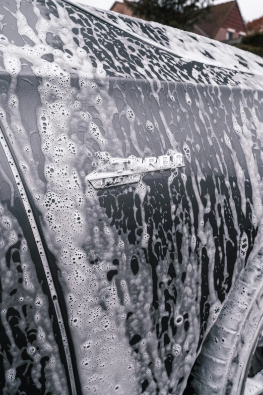 the car was covered in rain and rain drops