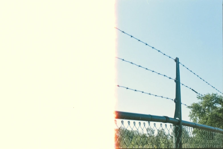 a person is running in the park next to a fence