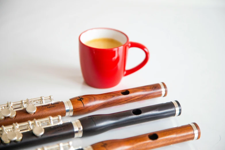 a coffee cup and a few flutes on a white table