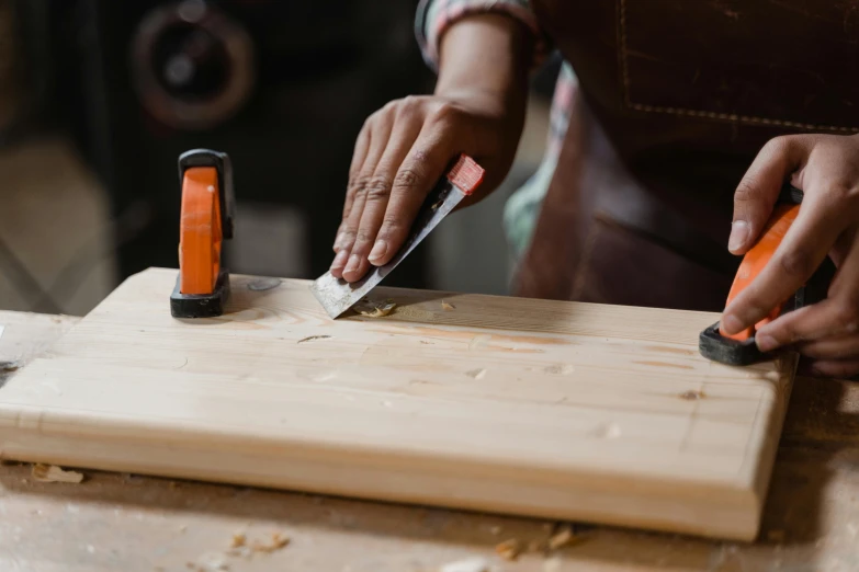 a man that is using a knife to cut soing