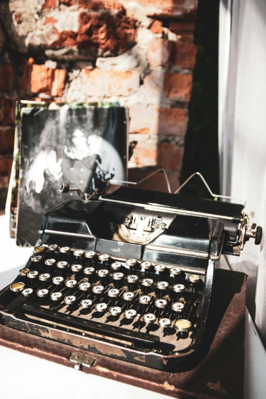 old fashioned typewriter with an open box sitting on top