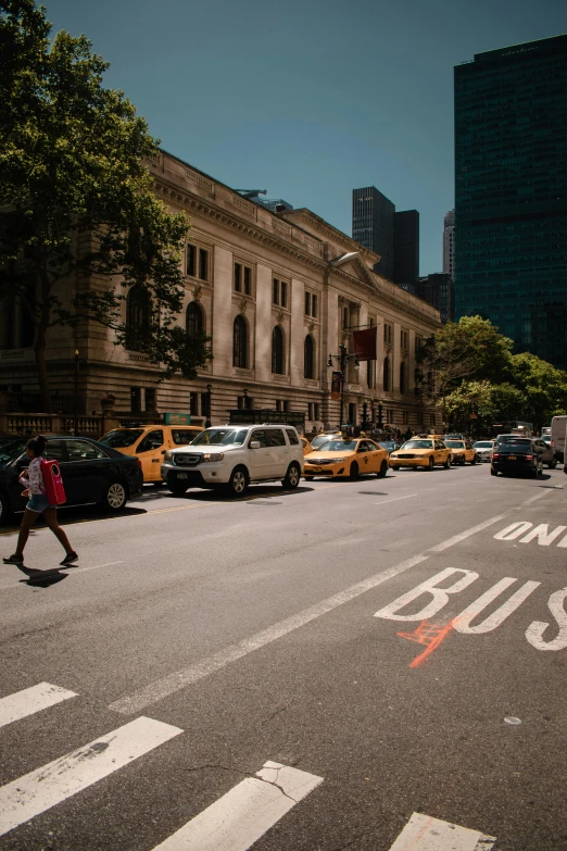 a city street filled with cars next to tall buildings