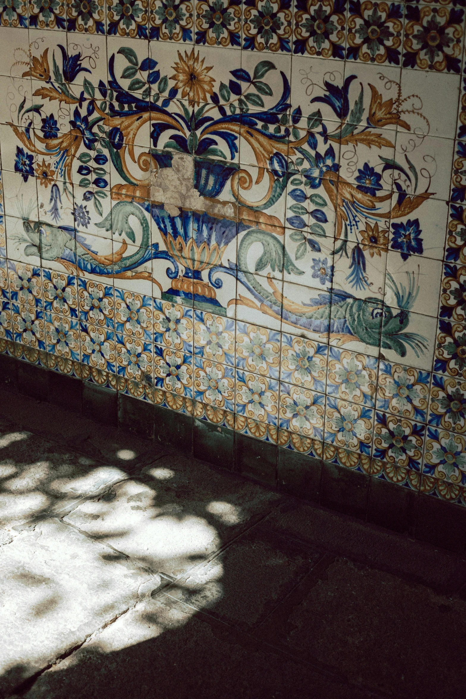 an artistic painting on a wall behind some chairs