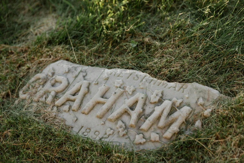 this sign reads athel street and sits on a patch of grass