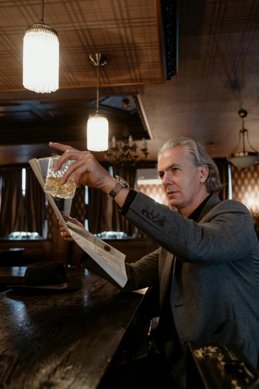 a man holding a plate of food on a bar