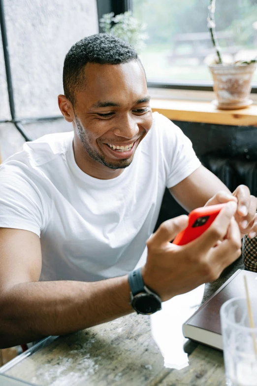 a man sitting at a table looking at his cell phone