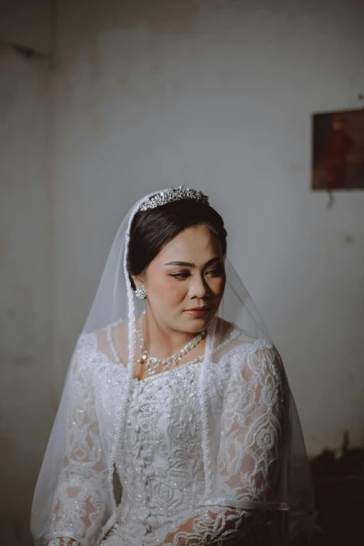 the bride is wearing a white veil