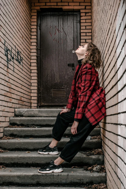 a man is sitting on steps next to a building