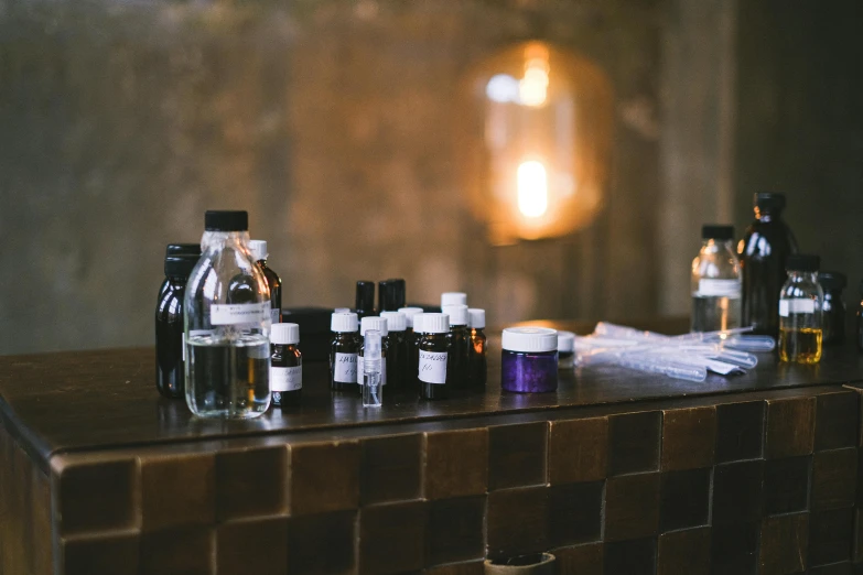 multiple bottles lined up next to each other on top of a dresser