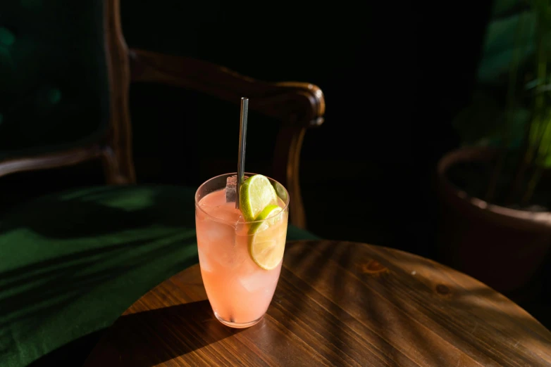 an alcoholic beverage sits on a wooden table