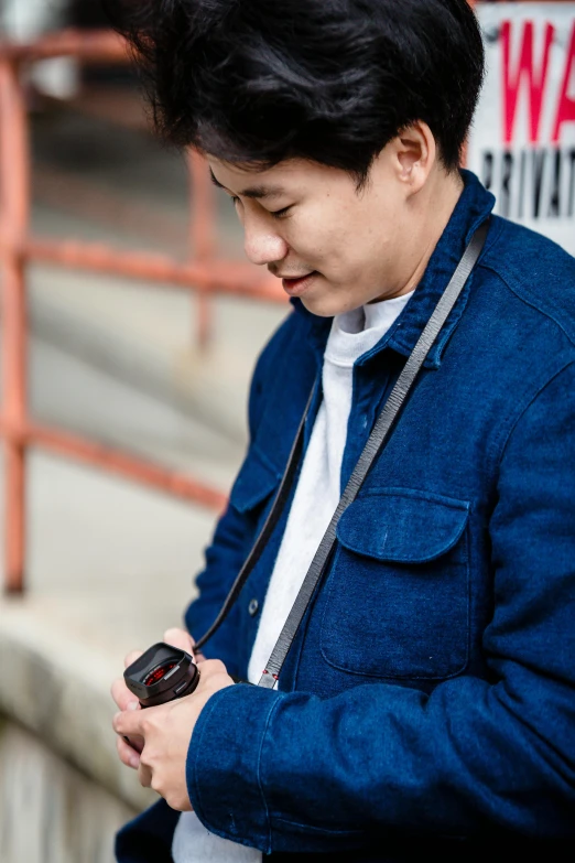 an asian man using his cell phone