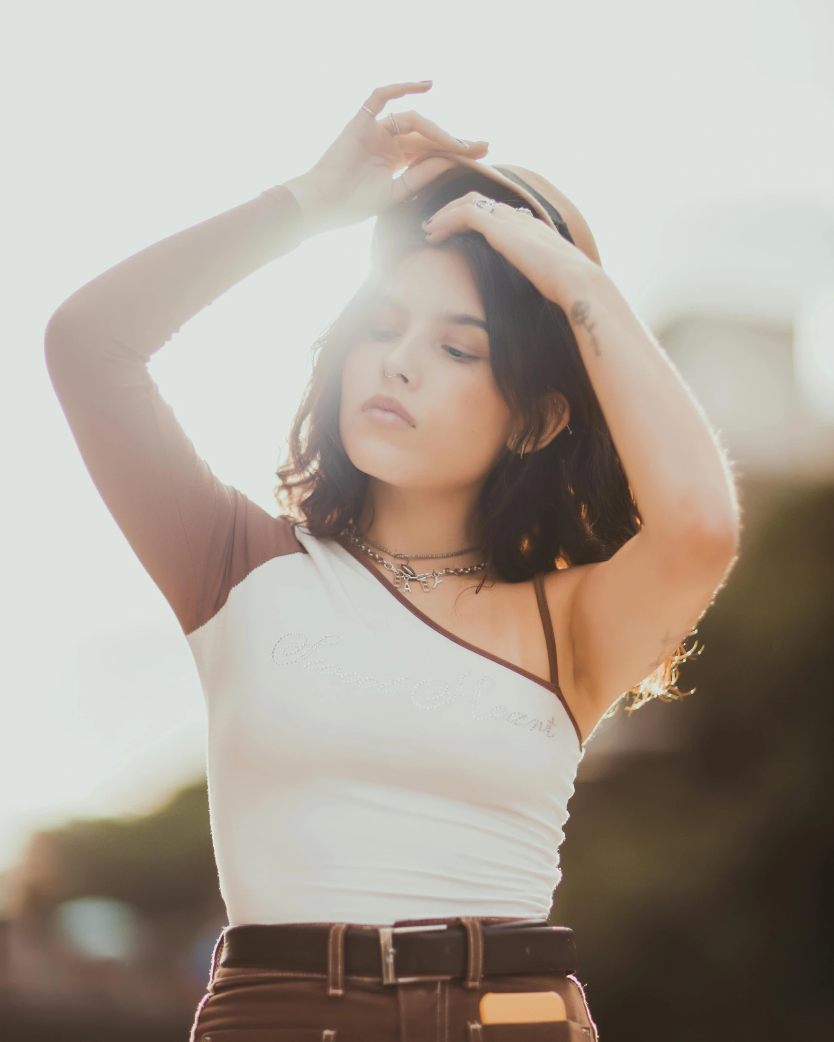 there is a young lady wearing a white shirt and brown pants