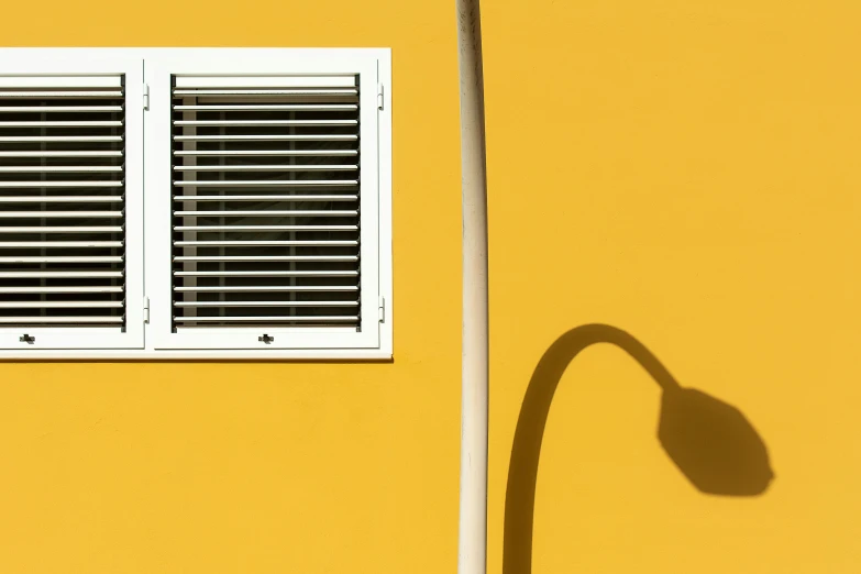 shadows cast on the corner of the white window and street lamp