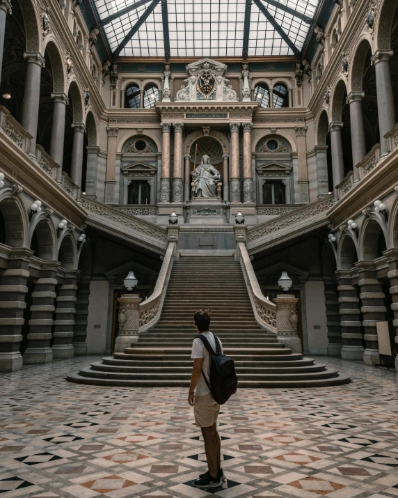 there is a man standing at the bottom of a staircase