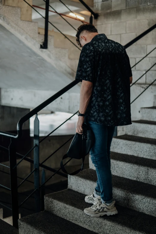 a man standing next to some steps in a building