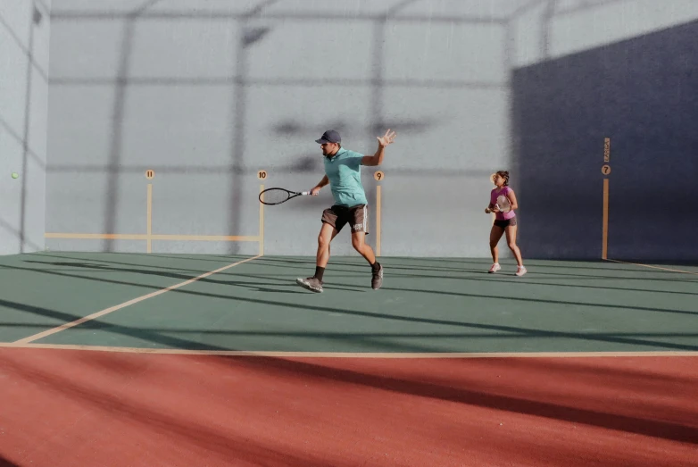 the man is playing tennis while another person holds his racket