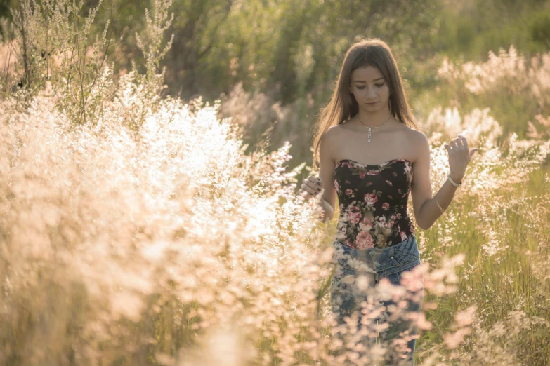 an asian woman with long hair walking in a field