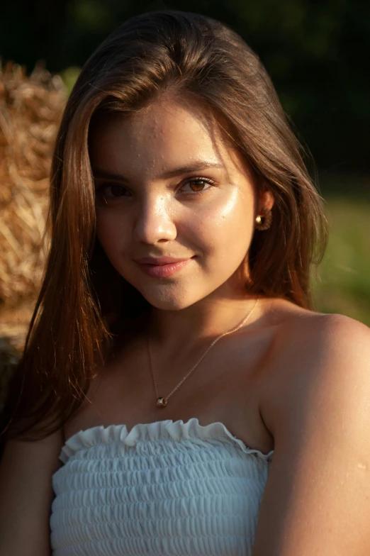 a woman in a strapless white dress smiles at the camera