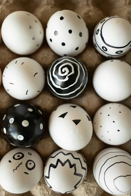 an assortment of painted eggs on a wooden crate