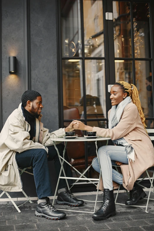 a man and woman sitting at table talking