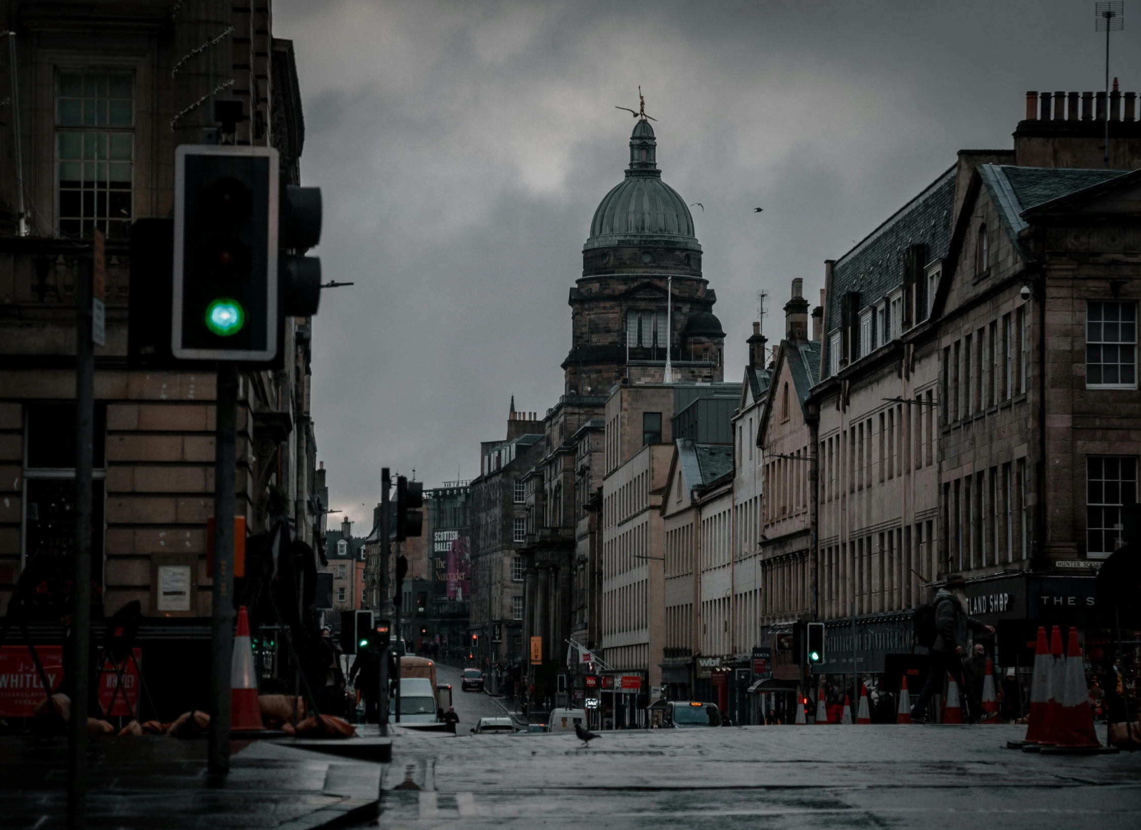 a green traffic light sits on the corner of the street