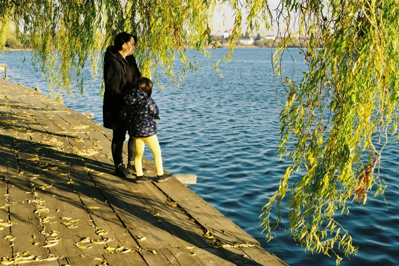 a couple on a dock next to the water