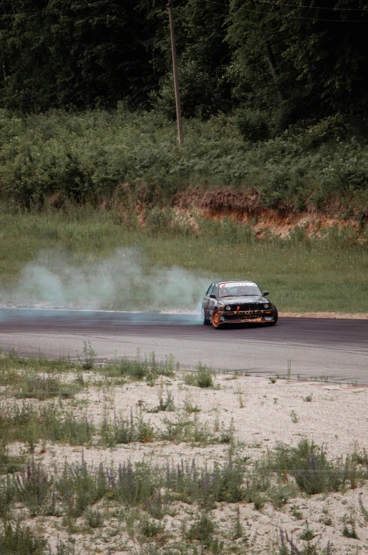 a person is riding in a car behind some smoke