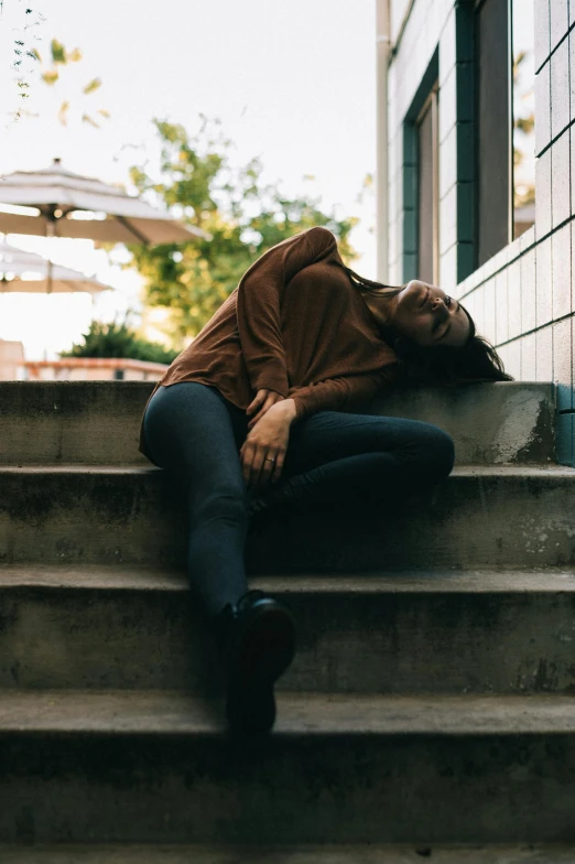 a person sitting down on some steps near a building