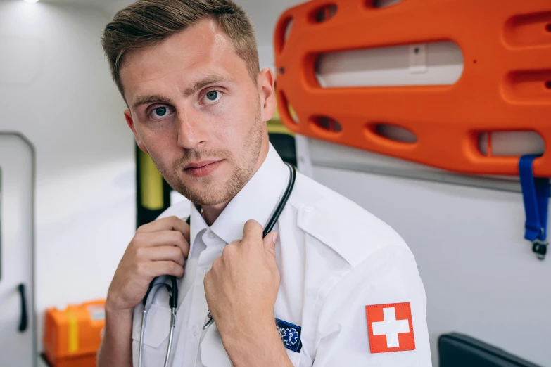 a man wearing a red cross collared shirt