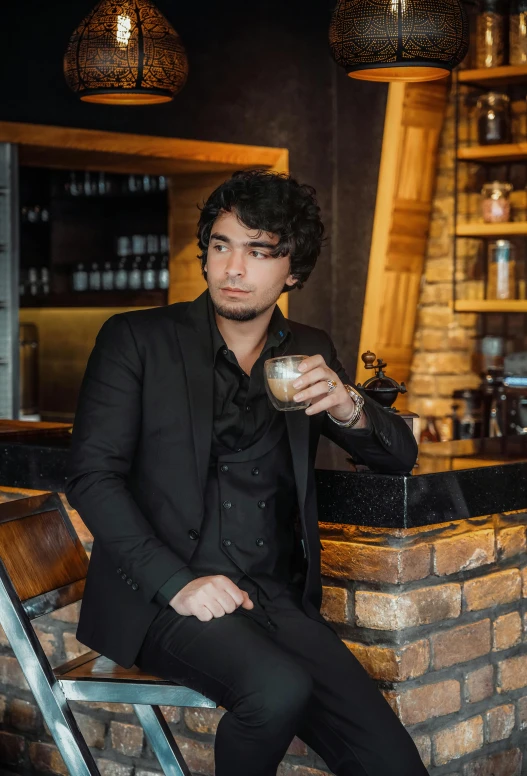 a man is sitting at the bar with a drink