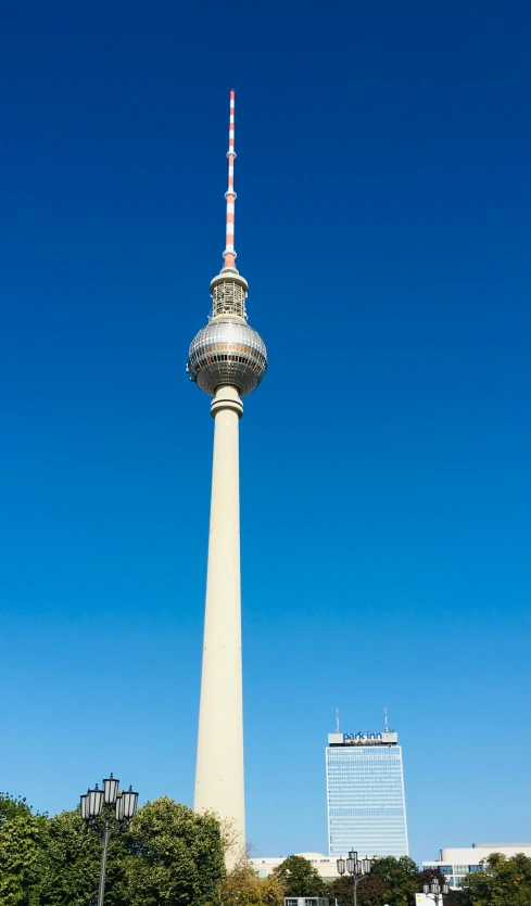 a large tower in the middle of a park