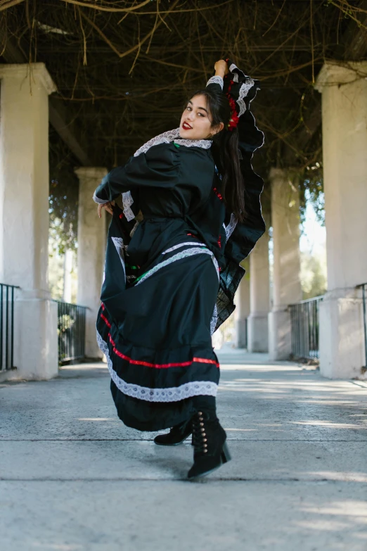 woman in black clothing poses for the camera